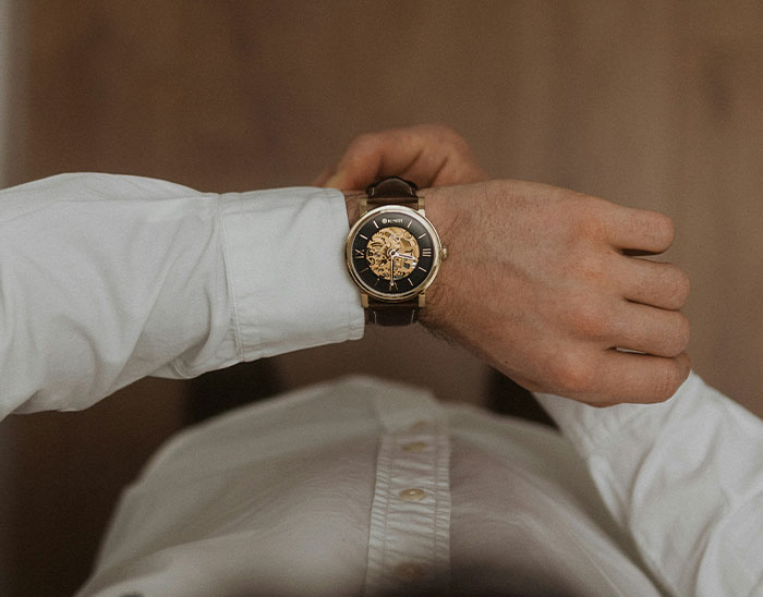 Person wearing a wristwatch, symbolizing lawyers evaluating cases and knowing these people are not winning their case.