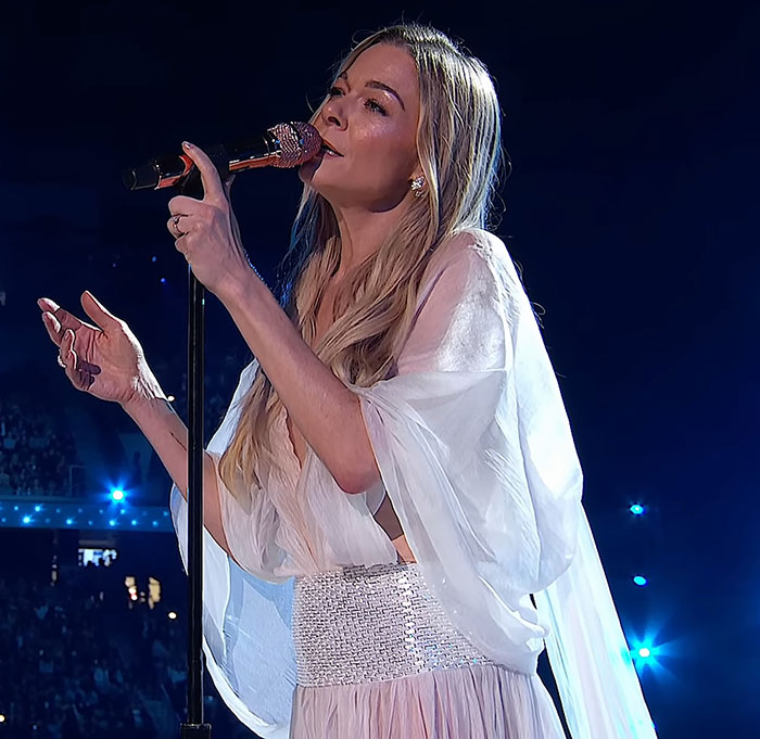 LeAnn Rimes performing on stage, wearing a light flowing outfit, during the moment her teeth fall out in panic. LeAnn Rimes performing on stage, wearing a light flowing outfit, during the moment her teeth fall out in panic.