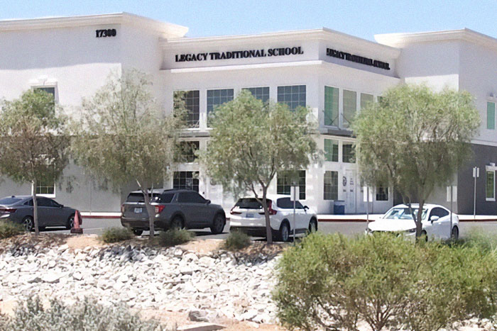 Legacy Traditional School building exterior with parked cars and trees in front on a sunny day, related to 5th grade girls revenge plot. Legacy Traditional School building exterior with parked cars and trees in front on a sunny day, related to 5th grade girls revenge plot.
