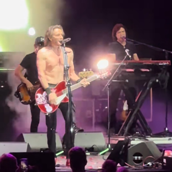 Famous 80s rockstar shirtless on stage playing guitar during a smoking hot live performance at age 75.