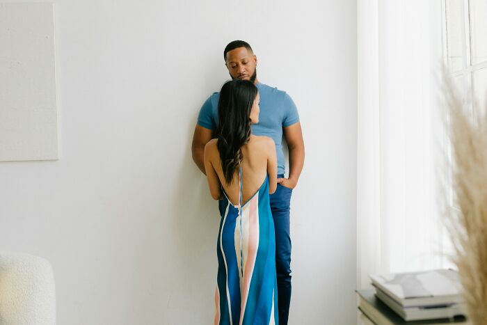 Couple standing close in a light room, illustrating challenges and emotions of modern dating experiences.