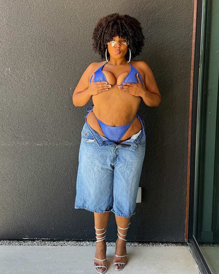 Lizzo posing in a blue bikini top and oversized jeans while addressing rumored Ozempic use and weight-loss method.