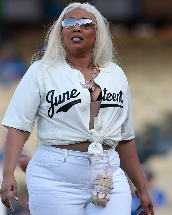 Lizzo wearing a June baseball jersey and sunglasses, addressing rumored Ozempic use and weight-loss method.