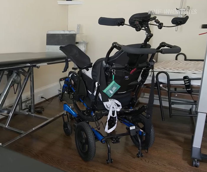 Motorized wheelchair in a room, highlighting the man stuck on a chair with locked-in syndrome after chiropractor visit.