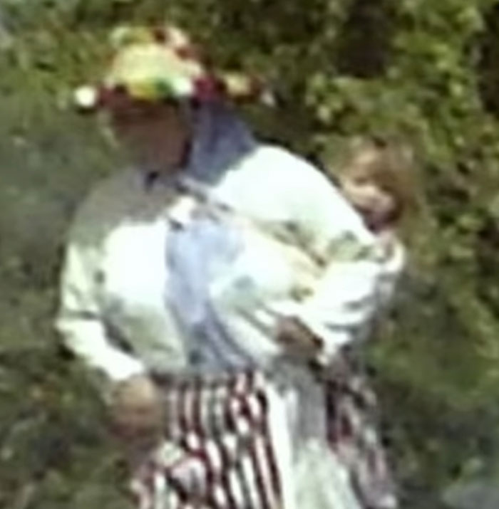 Blurred image of a person holding a child outdoors, related to disturbing new theory in Madeleine McCann run over by drunk driver.