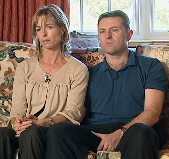 Couple sitting on a floral couch, looking serious and concerned amid Madeleine McCann mystery and bone discovery investigation. Couple sitting on a floral couch, looking serious and concerned amid Madeleine McCann mystery and bone discovery investigation.