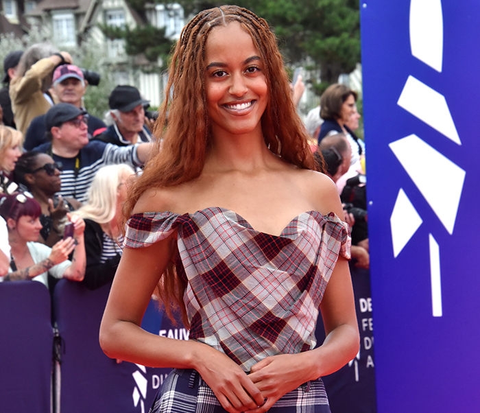 Malia Obama smiling at an event, with Michelle Obama breaking silence on daughter Malia dropping last name news. Malia Obama smiling at an event, with Michelle Obama breaking silence on daughter Malia dropping last name news.