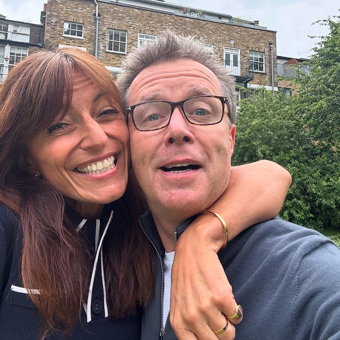 Man abandoned as baby in plastic bag and left in toilet embraces happy middle-aged woman outdoors after reunion.