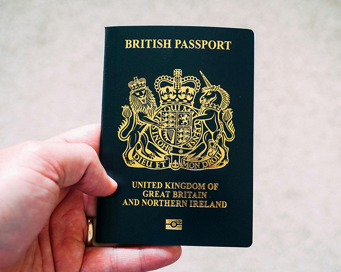 Hand holding a British passport, related to man with face tattoos deported by immigration officials. Hand holding a British passport, related to man with face tattoos deported by immigration officials.