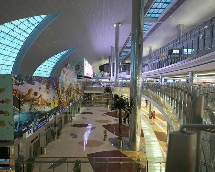 Modern airport interior with a man with face tattoos facing immigration officials during deportation process. Modern airport interior with a man with face tattoos facing immigration officials during deportation process.