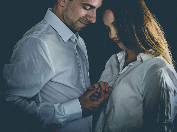 Couple sharing a romantic moment with man making woman feel special and standing out like a scene from a rom-com.