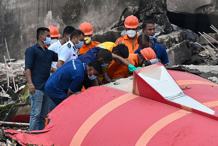 Rescue team inspecting wreckage of Air India plane crash near campus while young medical students share gut-wrenching stories.