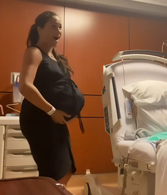 Pregnant woman in hospital room showcasing Meghan Markle twerking pregnancy video conspiracy theory.