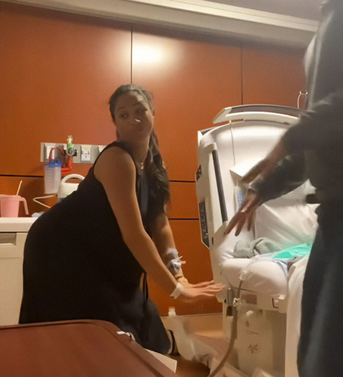 Pregnant woman twerking in hospital room, sparking Meghan Markle pregnancy conspiracy theory discussions.