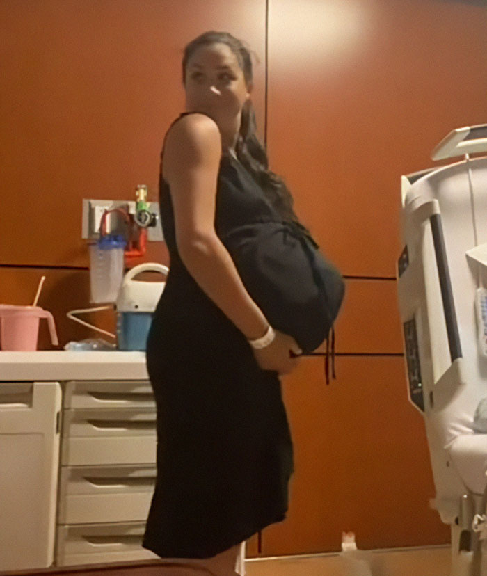 Woman in black dress standing in hospital room, related to Meghan Markle's Father's Day post controversy over paid child actors and rented kids. Woman in black dress standing in hospital room, related to Meghan Markle's Father's Day post controversy over paid child actors and rented kids.