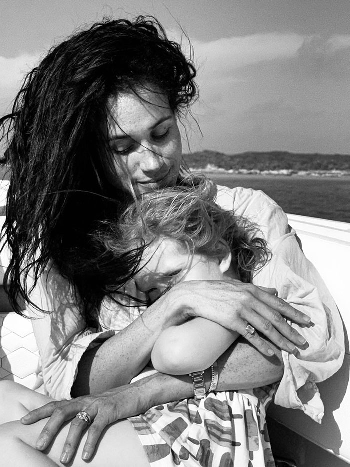 Meghan Markle holding child on boat, related to Meghan Markle twerking pregnancy video conspiracy theory.