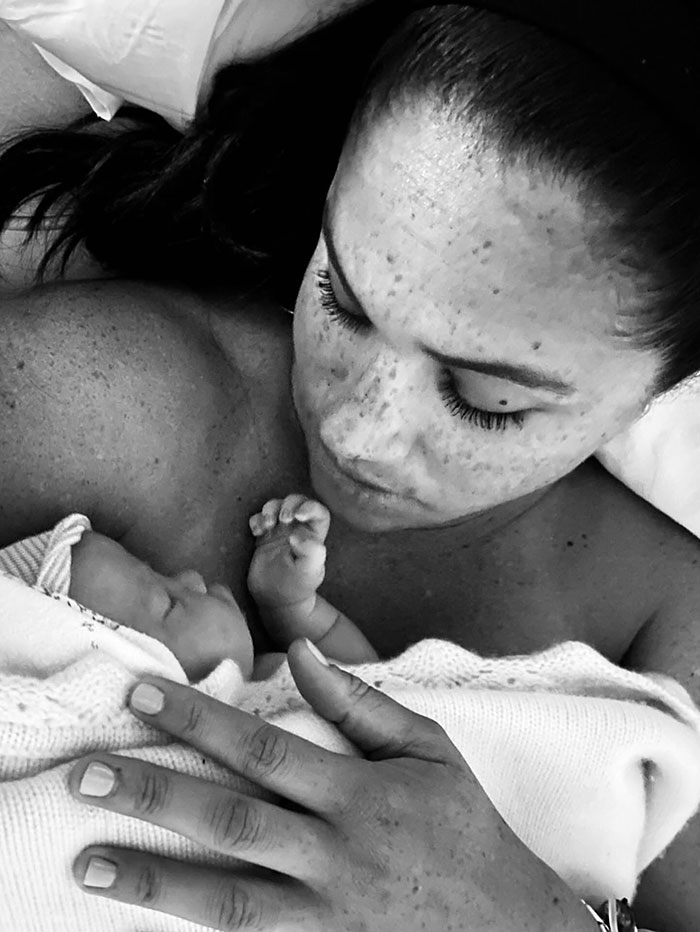 Meghan Markle holding a newborn baby close, sparking viral discussion about twerking pregnancy video and birth conspiracy theory.