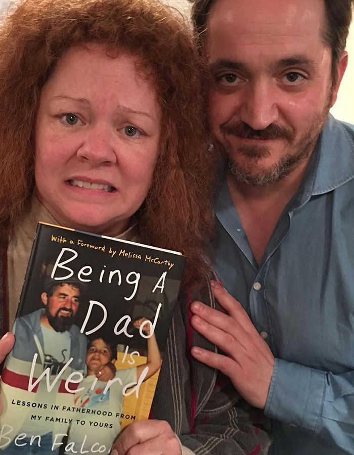 Melissa McCarthy holding a book with a man beside her, highlighting look-alike daughter for a major milestone celebration.