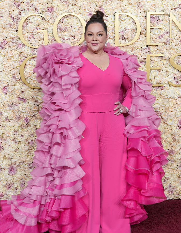 Melissa McCarthy wearing a bright pink ruffled outfit at an event, highlighting her look-alike daughter milestone post.