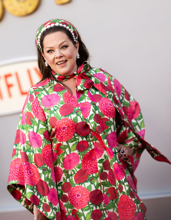 Melissa McCarthy posing in a vibrant floral outfit, celebrating a rare look-alike daughter milestone event.