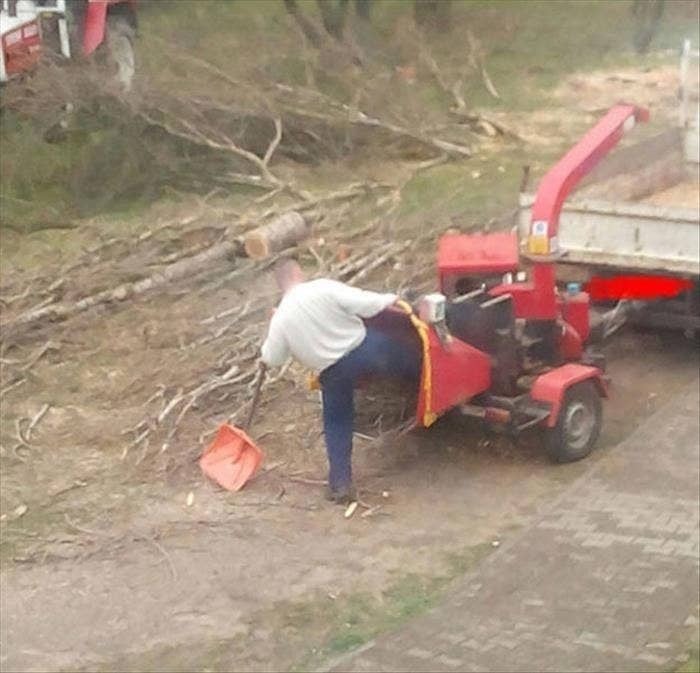 Man doing dumb things with a wood chipper, highlighting risky behavior explaining why women live longer than men.