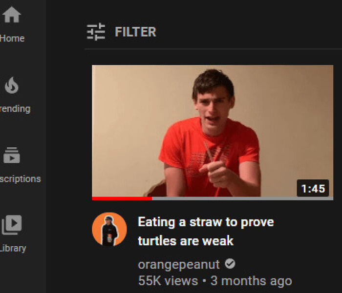 Young man in a red shirt eating a straw to prove turtles are weak, illustrating men doing dumb things humorously
