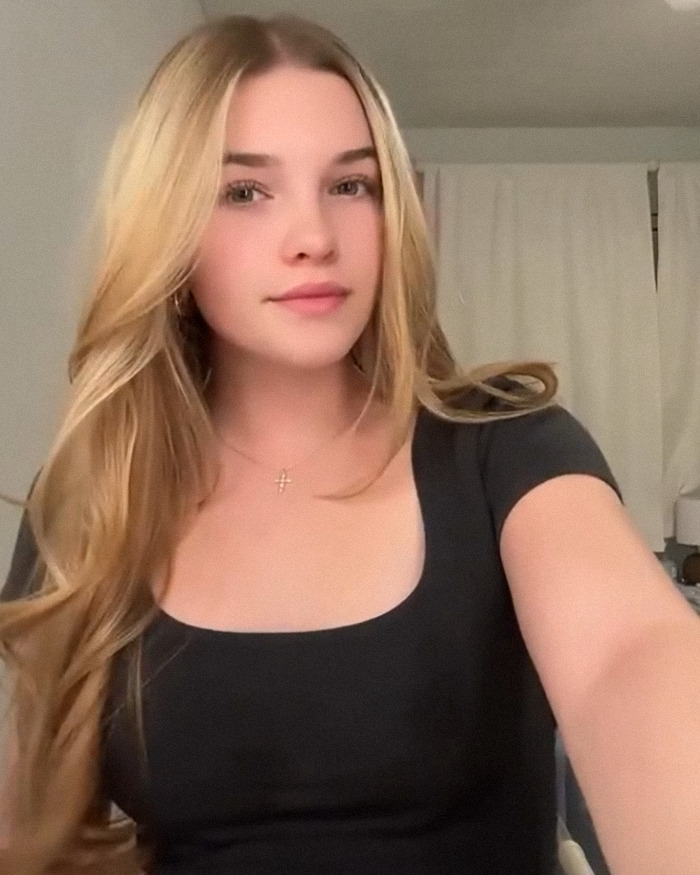 Beloved child star from Good Luck Charlie posing with long blonde hair and a grown-up look at age 16 indoors.