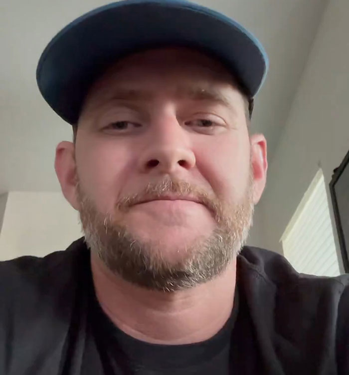 Man with beard and blue cap in casual setting representing Nick Offerman praised for brutal clapback against homophobe in church context Man with beard and blue cap in casual setting representing Nick Offerman praised for brutal clapback against homophobe in church context