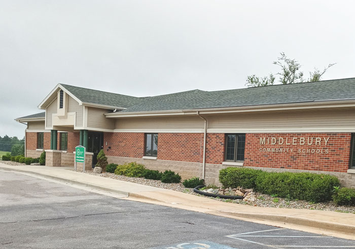 Middlebury Community Schools building exterior on a cloudy day related to teacher resignation over controversial t-shirt.