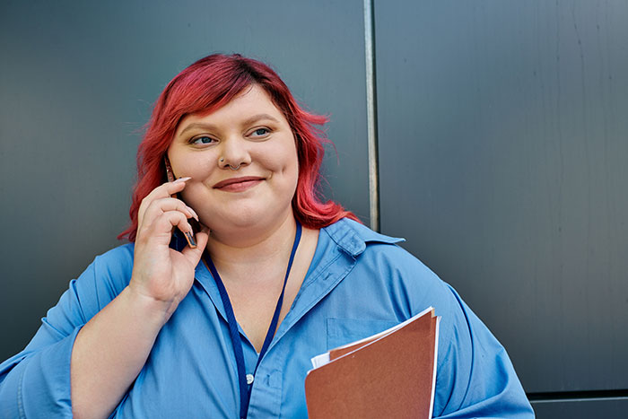 Woman calling CPS, holding folder, discussing accusation of forcing child to get a tattoo in a casual setting.