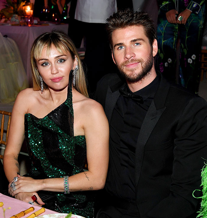 Miley Cyrus and Liam Hemsworth seated together at a formal event, highlighting celebrity relationship news and drama. Miley Cyrus and Liam Hemsworth seated together at a formal event, highlighting celebrity relationship news and drama.