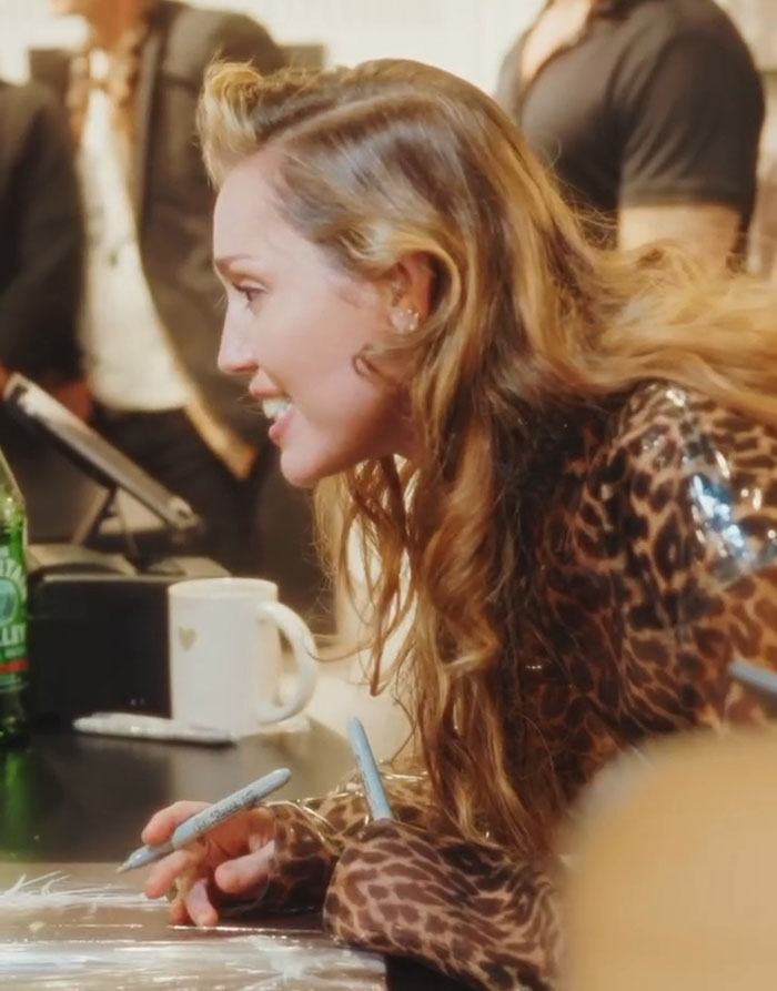 Miley Cyrus wearing leopard print, signing autographs, sparking heated reactions with comment about ex-husband Liam Hemsworth. Miley Cyrus wearing leopard print, signing autographs, sparking heated reactions with comment about ex-husband Liam Hemsworth.