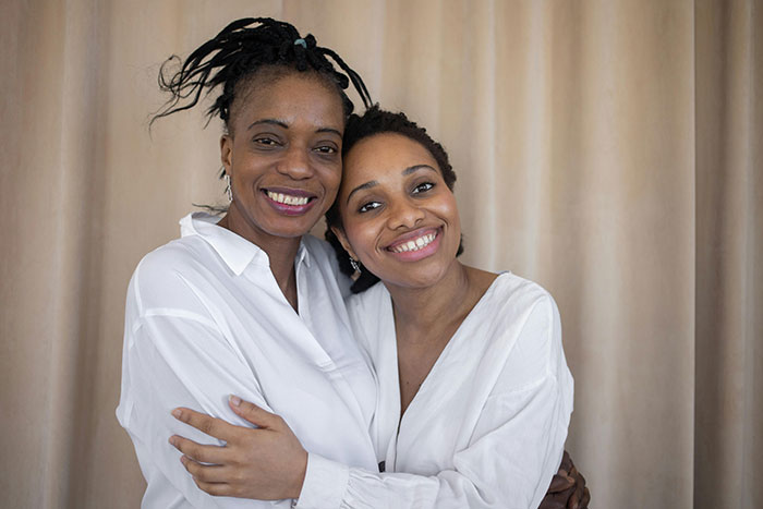 Mother and daughter smiling and hugging, sharing a special day out after a boys trip exclusion.