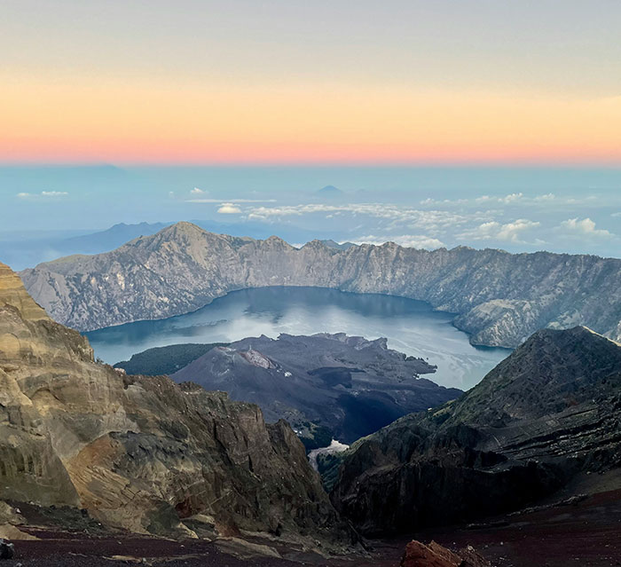 Volcano tours landscape at sunrise showing crater and lake with mountains, linked to disturbing claims after tourist's passing. Volcano tours landscape at sunrise showing crater and lake with mountains, linked to disturbing claims after tourist's passing.