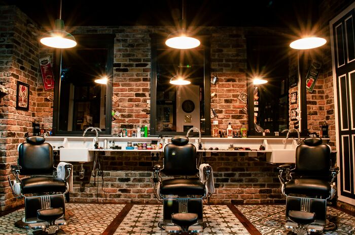 Barbershop interior with three black chairs and mirrors, illustrating the concept of famous paradoxes that confuse even smart people.