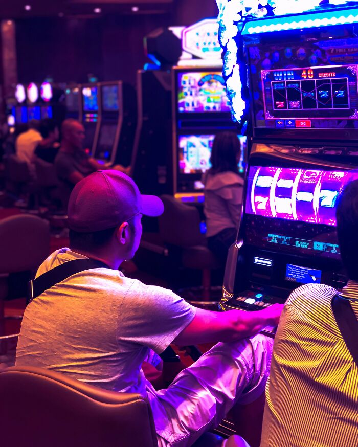 People playing slot machines in a casino, illustrating things they thought everyone knew but apparently don’t.