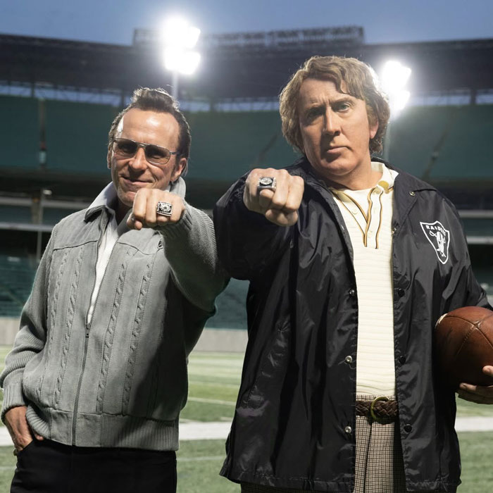 Actors on a football field set wearing rings, with one in a fat suit portraying legendary football coach John Madden. Actors on a football field set wearing rings, with one in a fat suit portraying legendary football coach John Madden.