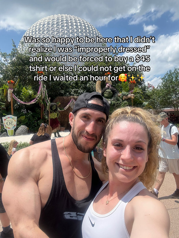 Woman at Disney complaints about staff scolding her for inappropriate outfit near iconic park attraction on a sunny day. Woman at Disney complaints about staff scolding her for inappropriate outfit near iconic park attraction on a sunny day.