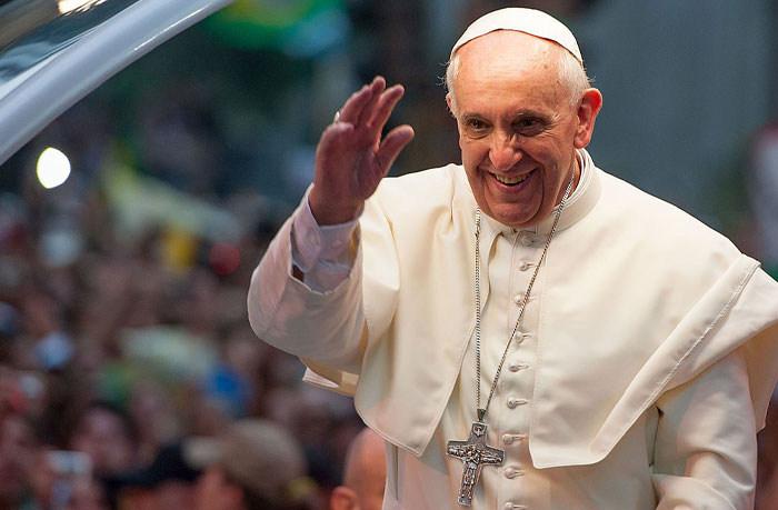 Pope Francis smiling and waving to a crowd, symbolizing themes of cosmic chaos and Nostradamus predictions for 2025.