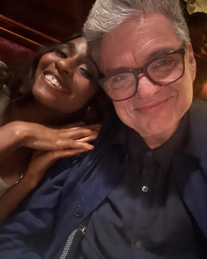 Two people smiling closely together in a dimly lit setting, featuring a super underrated 90s actor looking unrecognizable. Two people smiling closely together in a dimly lit setting, featuring a super underrated 90s actor looking unrecognizable.