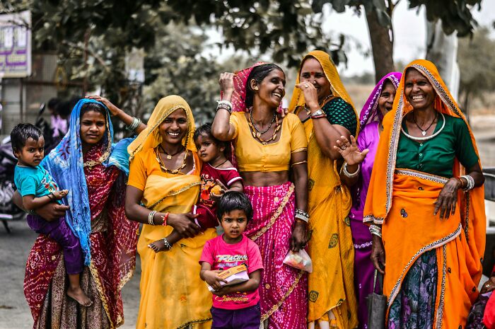 Group of women and children dressed in colorful traditional clothing representing one Mississippi counting countries diversity.