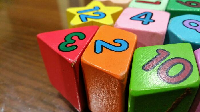 Colorful wooden blocks with numbers arranged on a table, illustrating one Mississippi counting countries concept.