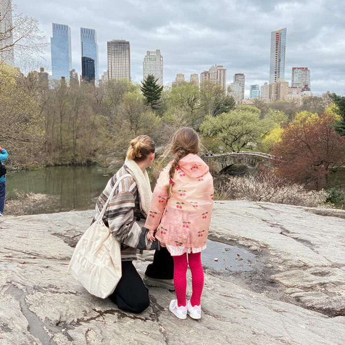Gigi Hadid with daughter Khai outdoors in park, overlooking city skyline and stone bridge on cloudy day Gigi Hadid with daughter Khai outdoors in park, overlooking city skyline and stone bridge on cloudy day