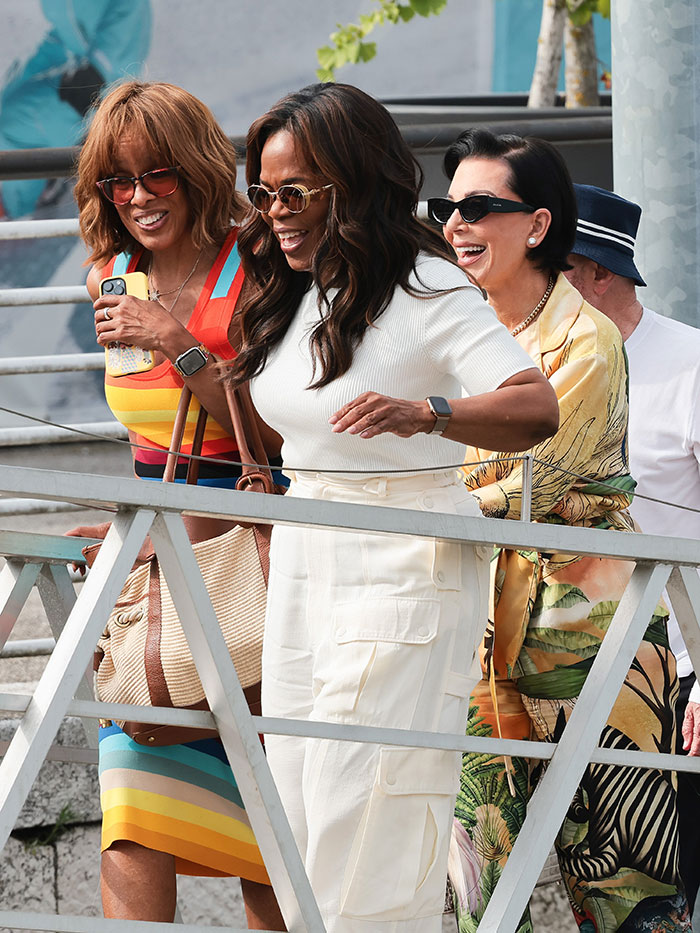 Three women smiling in sunglasses, dressed stylishly during an outing showing strung-out celebrity looks after weekend partying