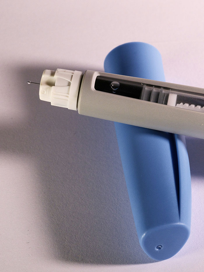 Ozempic injection pen with a blue cap, used for managing blood sugar and related health conditions.