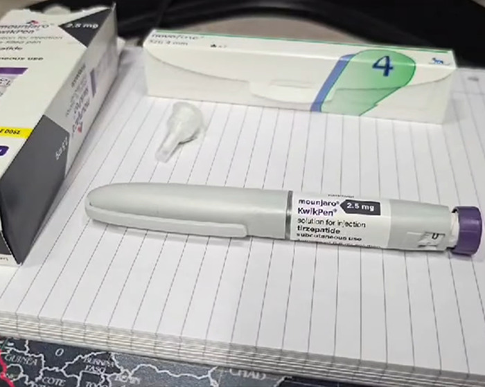 Mounjaro injection pen and Ozempic box placed on a notebook, highlighting organ-destroying drug concerns.