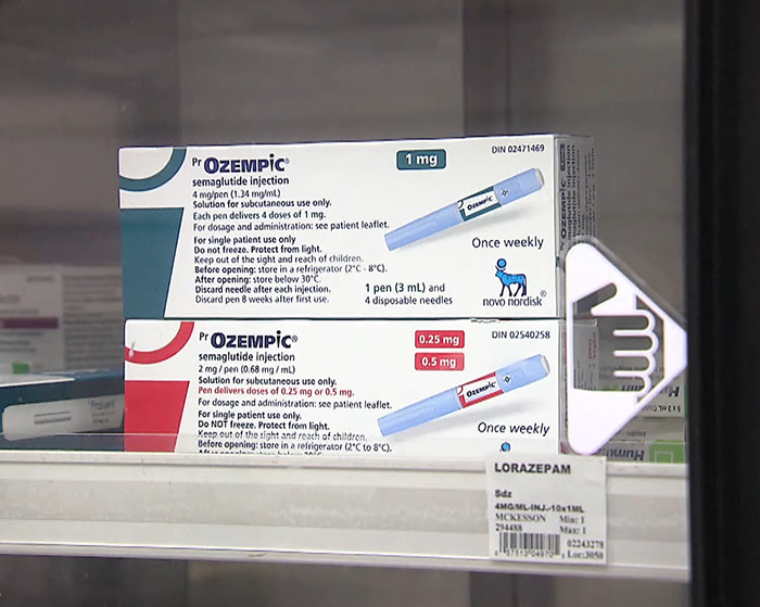 Boxes of Ozempic semaglutide injection pens displayed in a pharmacy, linked to organ-destroying risks by experts.