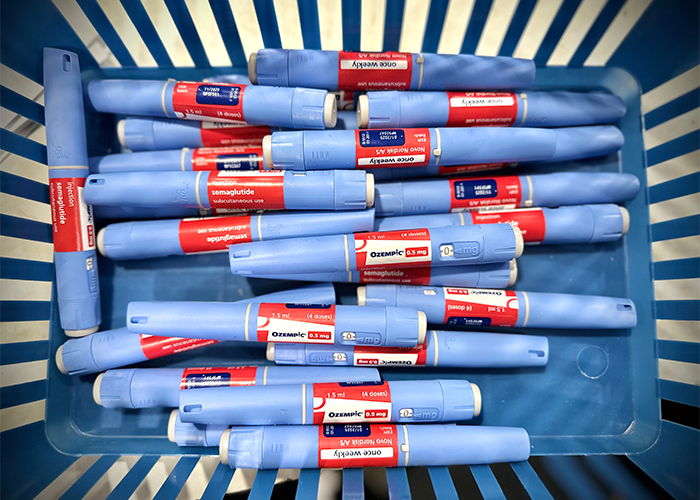 Blue Ozempic injection pens arranged in a basket, highlighting Ozempic side effects related to men's health concerns.