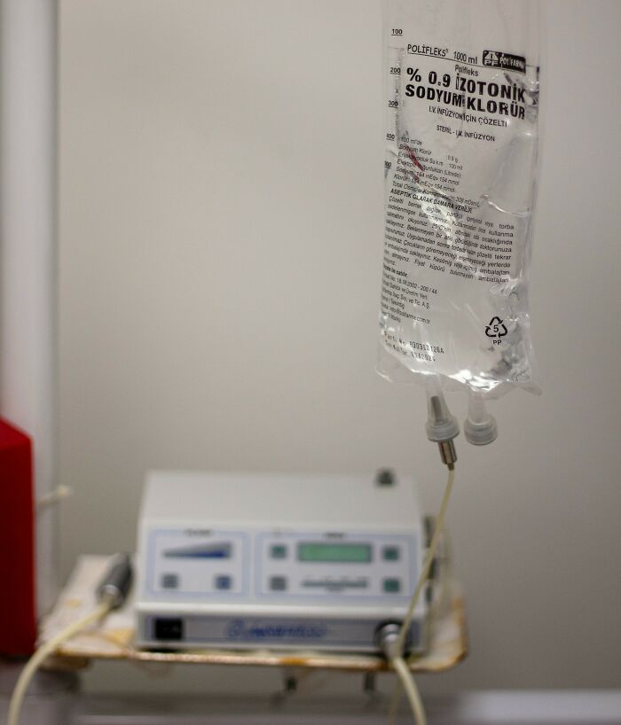 IV drip bag with medical equipment in a clinical setting, representing a coworker diabolical things report HR context.