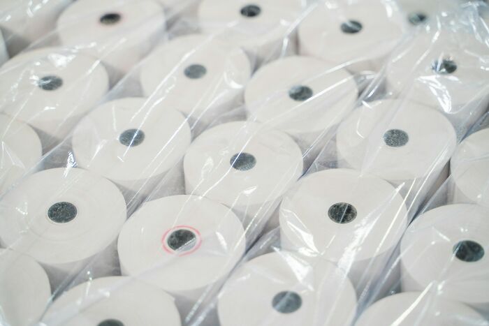 Multiple rolls of receipt paper tightly wrapped in plastic, highlighting unresolved personal mysteries of people.